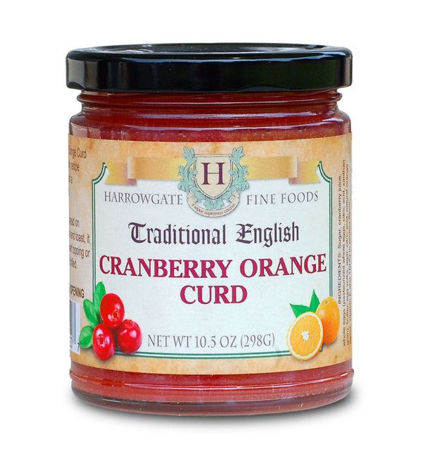 A jar of Cranberry-Orange Curd made by Harrowgate Fine Foods. Picture of a cluster of cranberries and a cut orange on the front label.