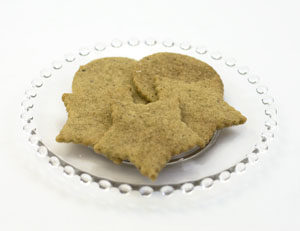 vanilla chai shortbread cookies on glass plate. 5 cookies are on the plate; 3 round wafers; three star shaped wafers.