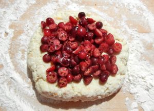 Chopped cranberries on top of scone dough