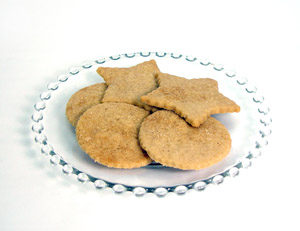 Wafer thin shortbread cookies made from brown sugar shortbread cookie mix. Two stars, 3 rounds sitting on clear glass plate.